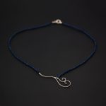 Klänge och lås av silver, collier av färgade lapis lazulir.